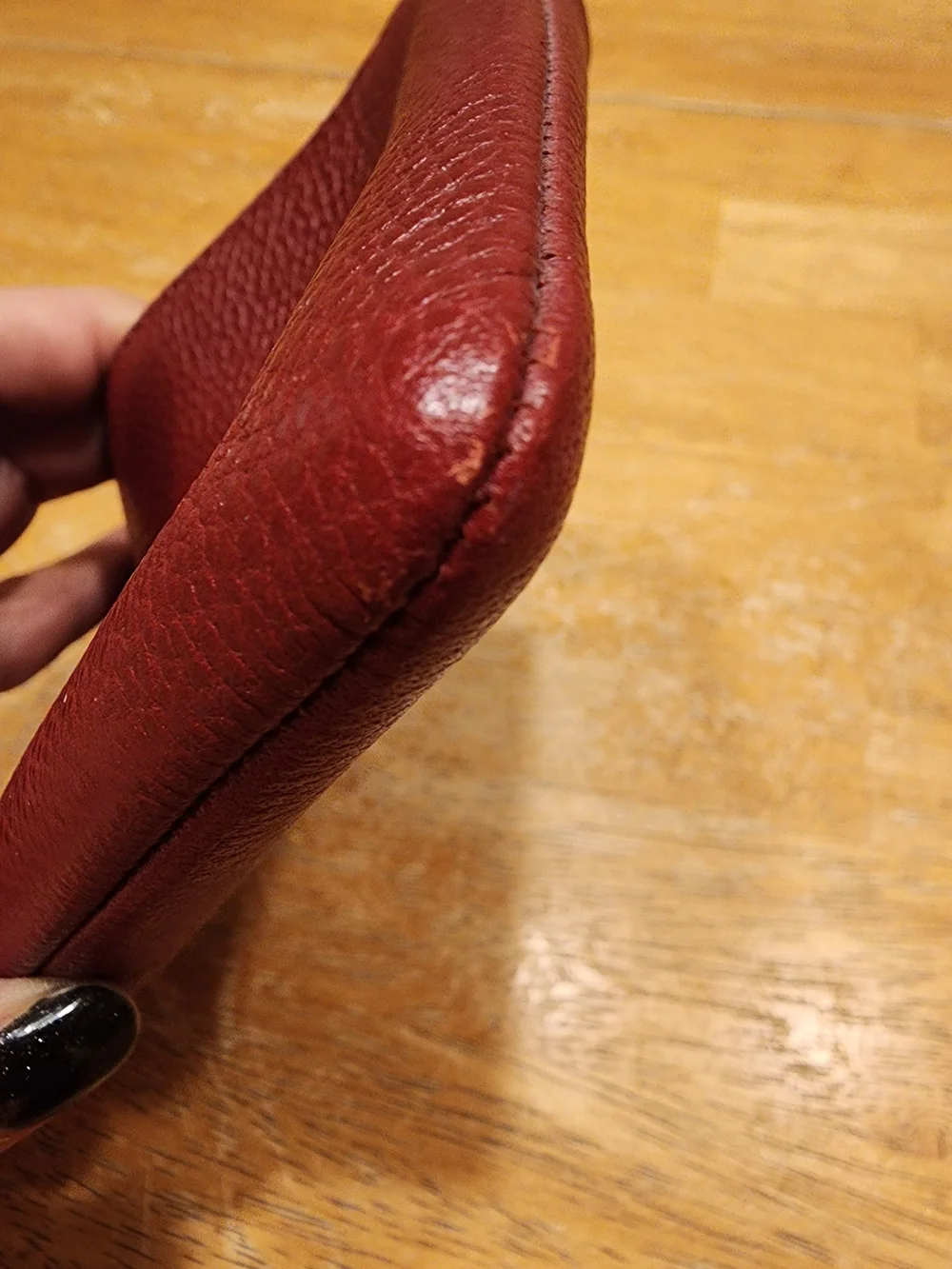 red polished pebble leather Coach wristlet, featuring gold-tone hardware